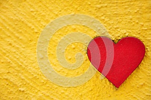 Red wooden heart on the wall background