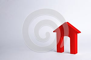 Red wooden house with a large doorway on a white background. The concept of buying and selling real estate, rental housing.