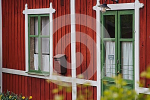 Red wooden house with white frames. Old house