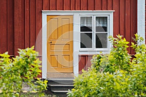 Red wooden house with white frames. Old house