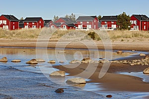 Red wooden houses near Marjaniemi beach, Hailuoto island. Finland