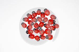 Red wooden ladybugs for decoration on a white