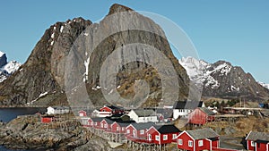 Red wooden Rorbu cabins in the in the Lofoten Islands. Traditional fishing village, with red rorbu houses against snowy