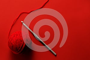 Red wool and crochet needle