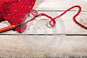 Red woollen string and chrochet hook on wood, Hobby Handiwork