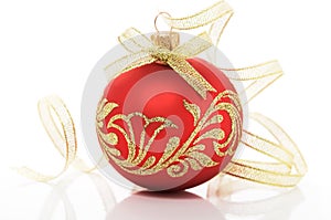 Red xmas ball and golden ribbon on white background