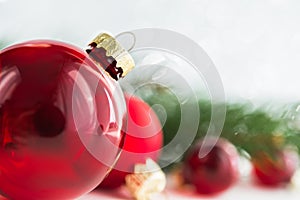 Red xmas ornaments on glitter holiday background. Merry christmas card.