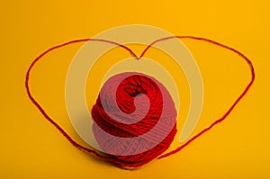 Red yarn with heart symbol