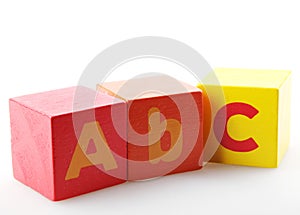 Red and yellow alphabet wooden blocks  on the white background