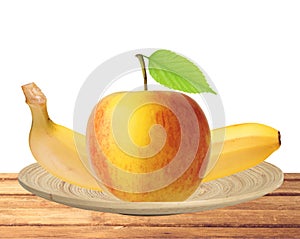 Red and yellow apple fruit with green leaf and banana in plate i