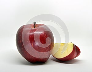 Red yellow apple with green leaf and slice