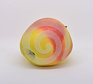 Red yellow apple with green leaf and slice