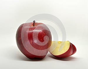 Red yellow apple with green leaf and slice