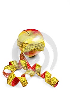 Red-yellow Apple with a measuring tape on