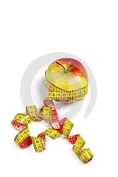 Red-yellow Apple with a measuring tape on