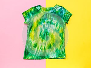 Red and yellow background with tie dye t-shirt. Flat lay.