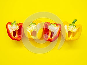 Red and yellow bell peppers sliced by the half with seeds