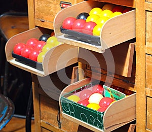 Red, yellow and black billiard balls at a vintage market