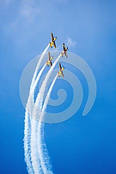 Red, yellow and blue airplanes performing stunts in the air. Aviation show with airplane aerobatics. photo