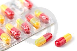 Red and yellow capsule pills in blister isolated