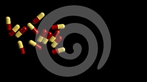 Red, yellow capsule pills on dark background. Antimicrobial resistance concept.