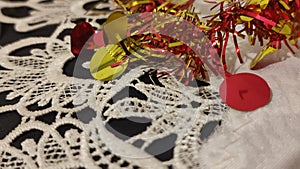 red and yellow Christmas garland, white lace tablecloth