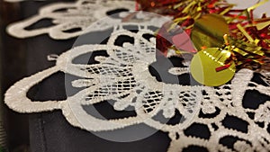 red and yellow Christmas garland, white lace tablecloth