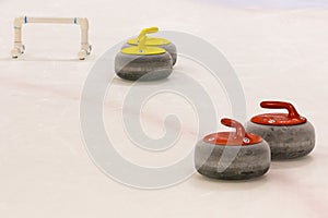 Red and Yellow Curling Stones with Stabilizer Bar
