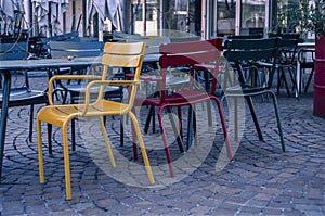 Red and yellow empty chairs of a closed restaurant during the coronavirus lockdown in Zurich