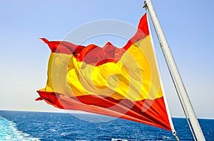 A red and yellow flag is flying in the ocean