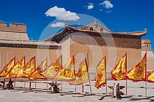 Red and yellow flags in front of traditional Chinese buildings a