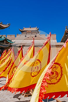 Red and yellow flags in front of traditional Chinese buildings a