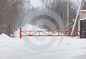 A red and yellow gate is in the snow