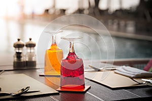 Red and Yellow Glass of water on luxury table setting