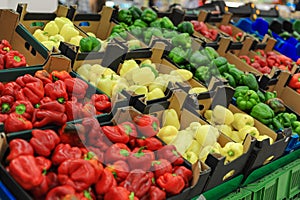 Red, yellow, green bell pepper on the counter