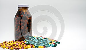 Red, yellow, green, blue antibiotic capsule pills and amber bottle, drug resistance