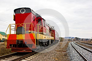Red-yellow locomotive train on the tracks