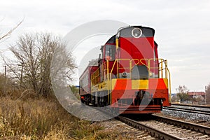 Red-yellow locomotive train on the tracks