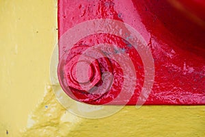 Red and yellow painted steel nut and bolt texture