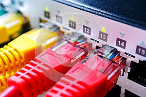 Red and yellow patch cords in the switch, many working ports of the custom switch for Internet service