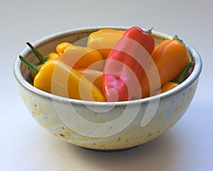 Red and Yellow Peppers in Ceramic Bowl