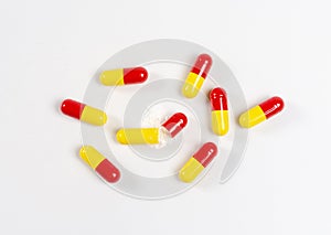 red and yellow pills white background, health and nature, top view, copy space