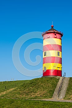 Red and Yellow Pilsum Lighthouse with Clear Blue Sky in East Frisia, Lower Saxony, Germany
