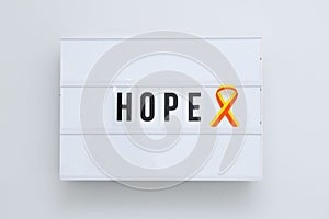 Red-yellow ribbon as symbol awareness of World hepatitis day on lightbox