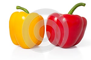 Red and yellow sweet pepper on a white