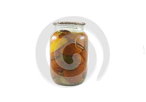 Red and yellow tomatoes canned in the small glass jar isolated