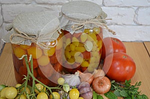 Red and yellow tomatoes in a jar