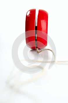 Red yoyo with thread over white