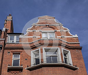 A redbricked house and the blue skies.