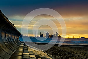 Redcar beach at sunset. Industrial background.